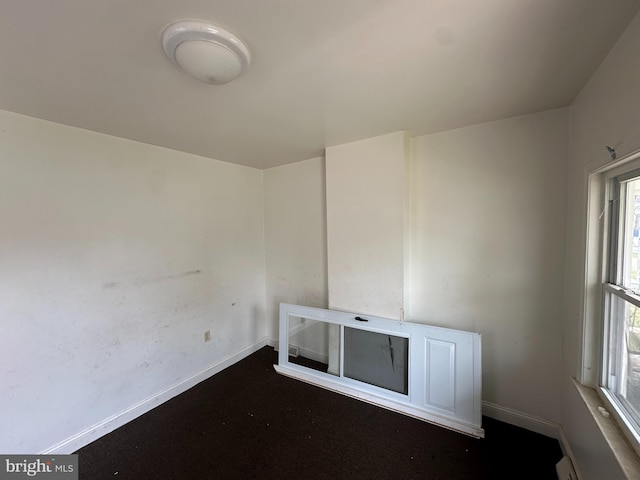 spare room with baseboards