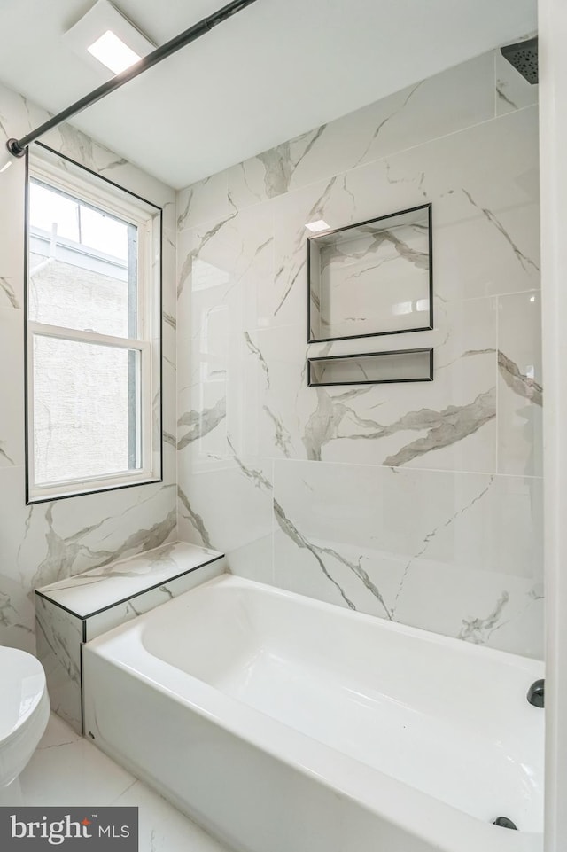 bathroom with bathtub / shower combination and toilet