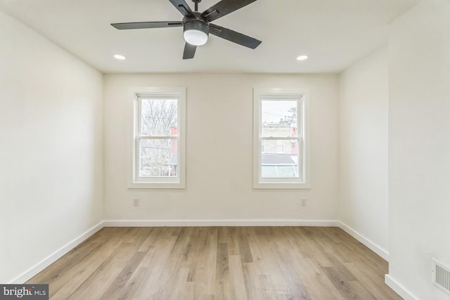 empty room featuring recessed lighting, light wood-type flooring, and baseboards