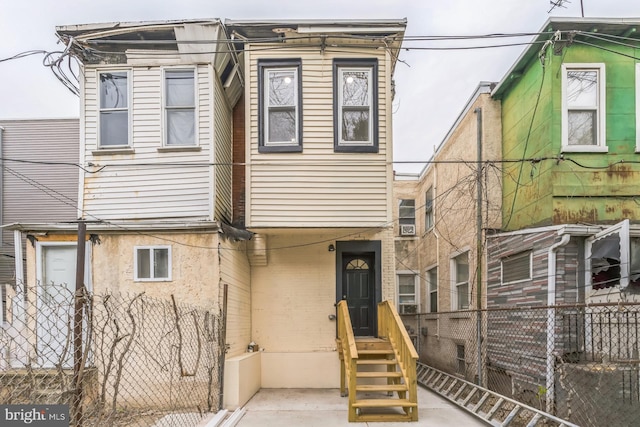 view of front of home featuring fence