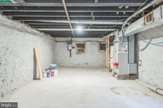 unfinished basement featuring heating unit