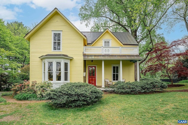1112 Park St, Charlottesville, VA 22901 - view of front facade with a porch, a front yard, and metal roof