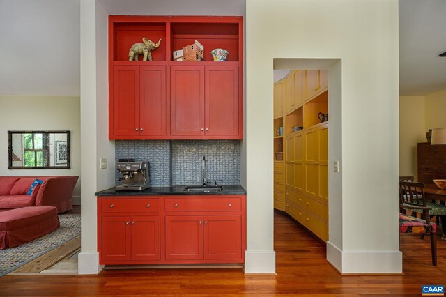 1112 Park St, Charlottesville, VA 22901 - kitchen featuring open shelves, tasteful backsplash, wood finished floors, and a sink