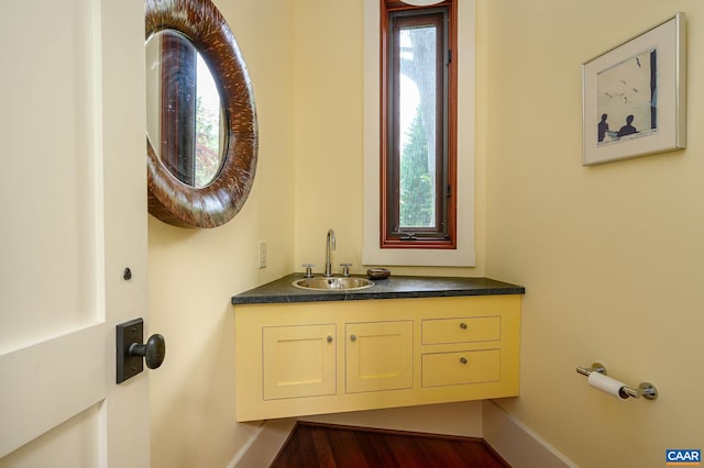1112 Park St, Charlottesville, VA 22901 - bathroom with baseboards, vanity, and wood finished floors