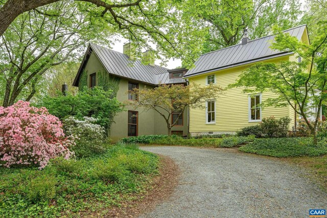 1112 Park St, Charlottesville, VA 22901 - exterior space featuring a standing seam roof, driveway, a chimney, and metal roof