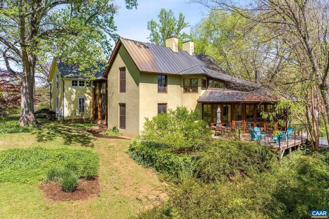 1112 Park St, Charlottesville, VA 22901 - back of property featuring a chimney, a yard, and stucco siding