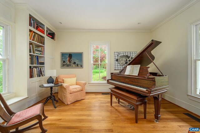 1112 Park St, Charlottesville, VA 22901 - sitting room featuring visible vents, crown molding, baseboards, light wood-style flooring, and built in shelves