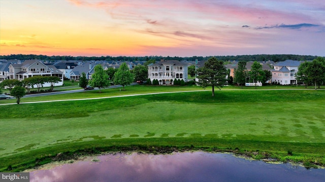 bird's eye view with a residential view, view of golf course, and a water view