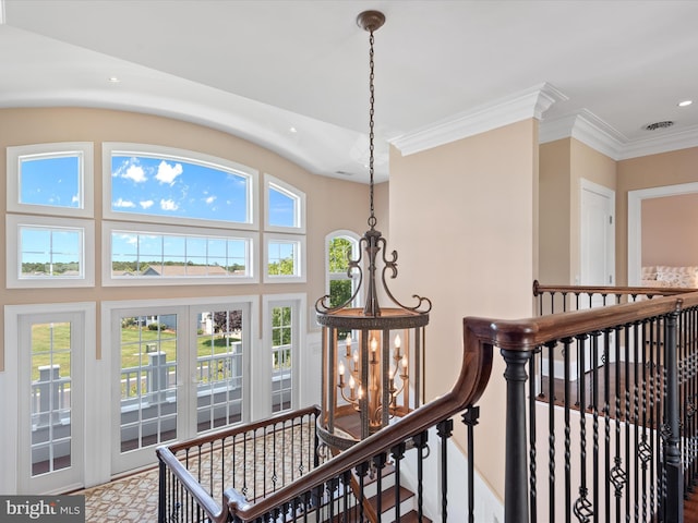 hall featuring an inviting chandelier, ornamental molding, visible vents, recessed lighting, and an upstairs landing