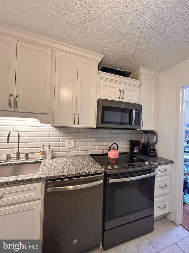 2300 Pimmit Dr Unit 601, Falls Church, VA 22043 - kitchen featuring a sink, decorative backsplash, dishwasher, electric range oven, and white cabinetry