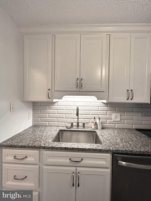 2300 Pimmit Dr Unit 601, Falls Church, VA 22043 - kitchen featuring a sink, dark stone countertops, backsplash, white cabinetry, and dishwasher
