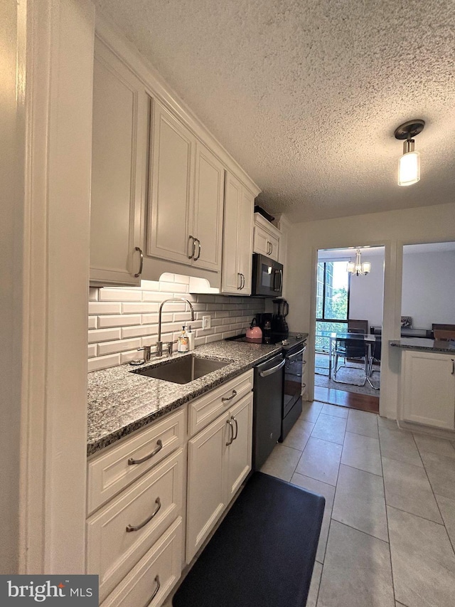 2300 Pimmit Dr Unit 601, Falls Church, VA 22043 - kitchen featuring a sink, a textured ceiling, tasteful backsplash, black microwave, and dishwasher
