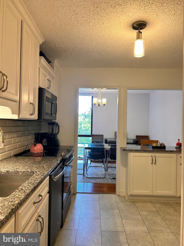 2300 Pimmit Dr Unit 601, Falls Church, VA 22043 - kitchen with stainless steel dishwasher, a textured ceiling, black microwave, an inviting chandelier, and backsplash