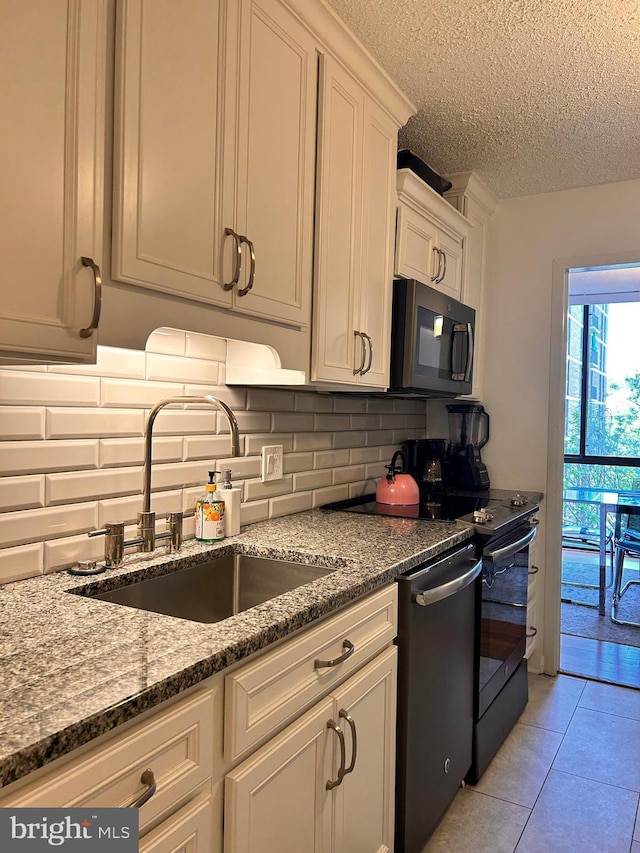 2300 Pimmit Dr Unit 601, Falls Church, VA 22043 - kitchen with backsplash, black microwave, a sink, and stove