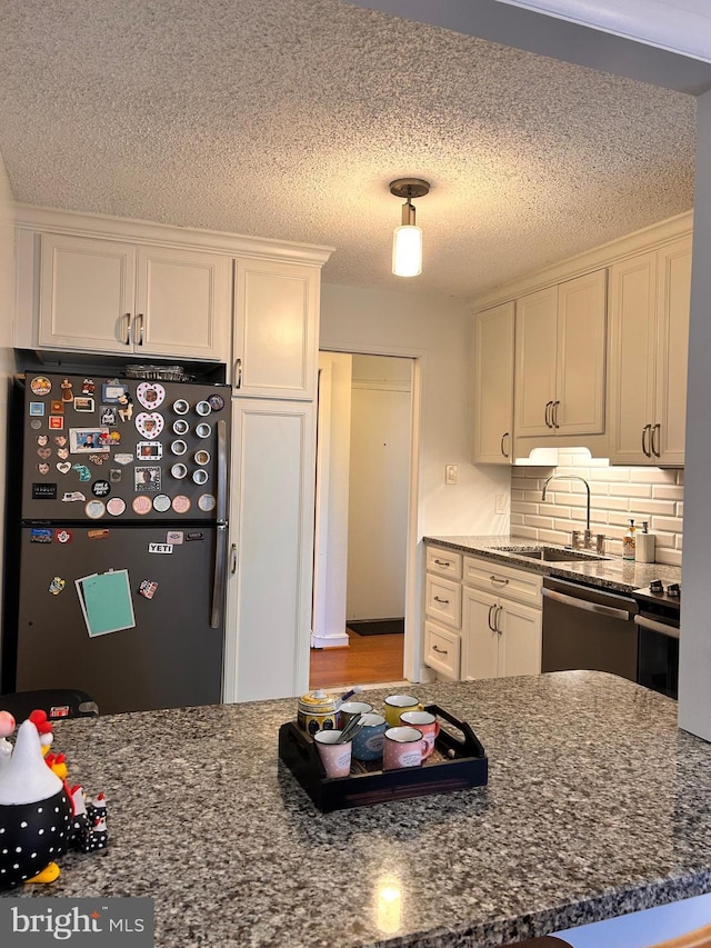 2300 Pimmit Dr Unit 601, Falls Church, VA 22043 - kitchen with white cabinets, appliances with stainless steel finishes, dark stone counters, and a sink