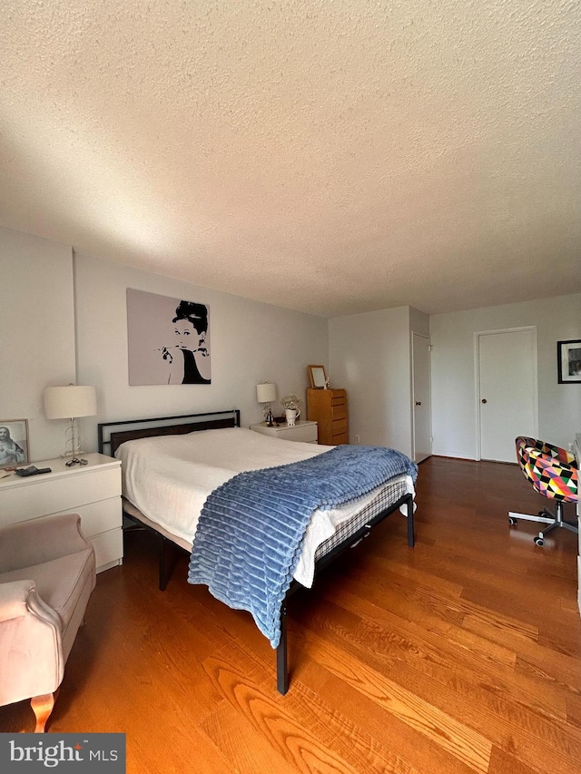 2300 Pimmit Dr Unit 601, Falls Church, VA 22043 - bedroom with wood finished floors and a textured ceiling