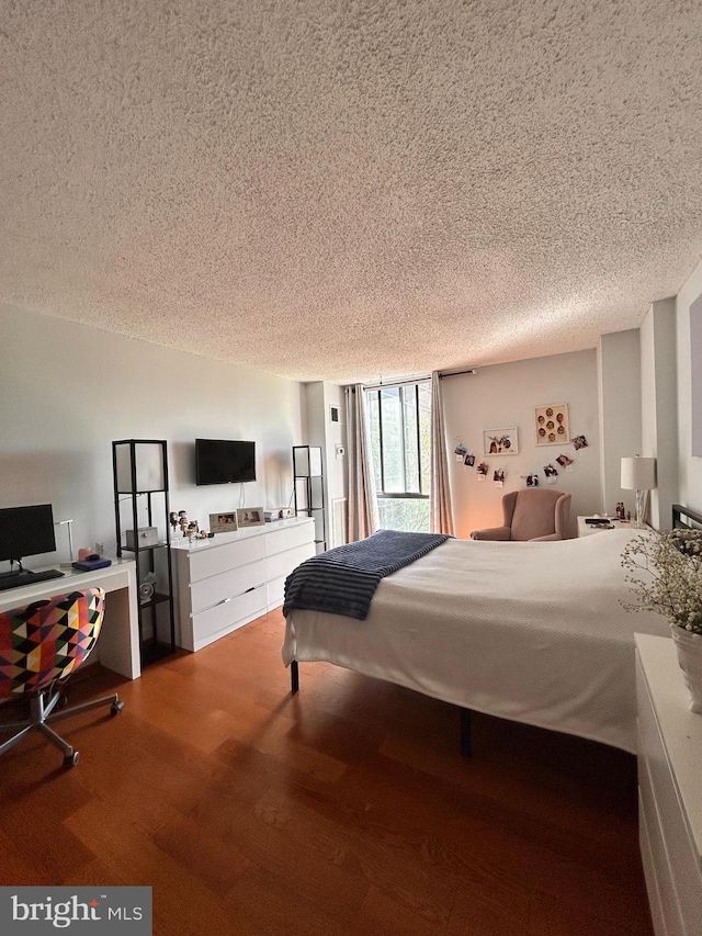 2300 Pimmit Dr Unit 601, Falls Church, VA 22043 - bedroom with wood finished floors and a textured ceiling