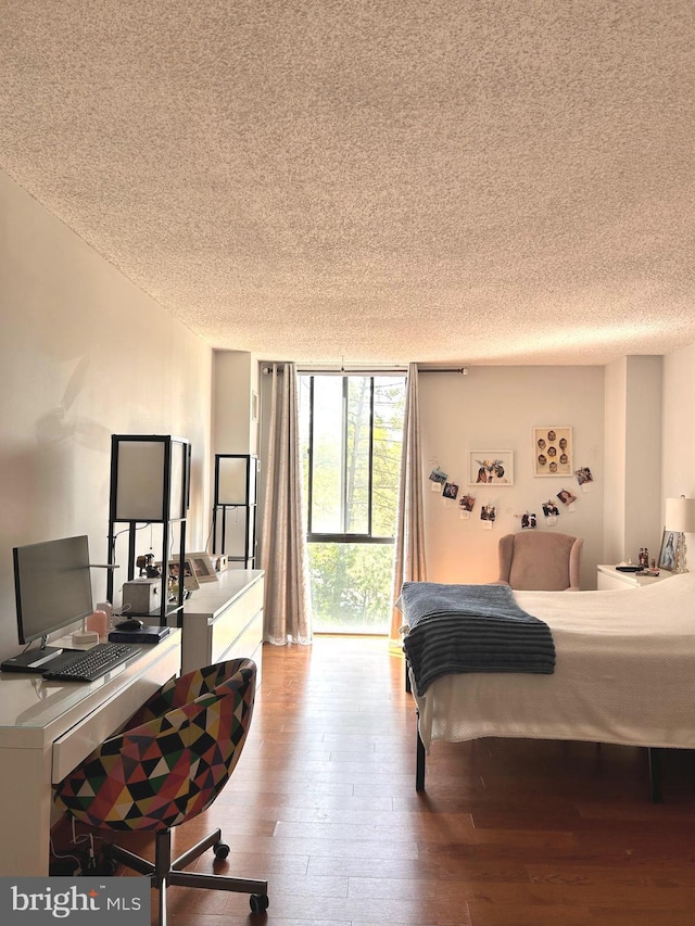 2300 Pimmit Dr Unit 601, Falls Church, VA 22043 - bedroom with hardwood / wood-style floors, a textured ceiling, and a wall of windows