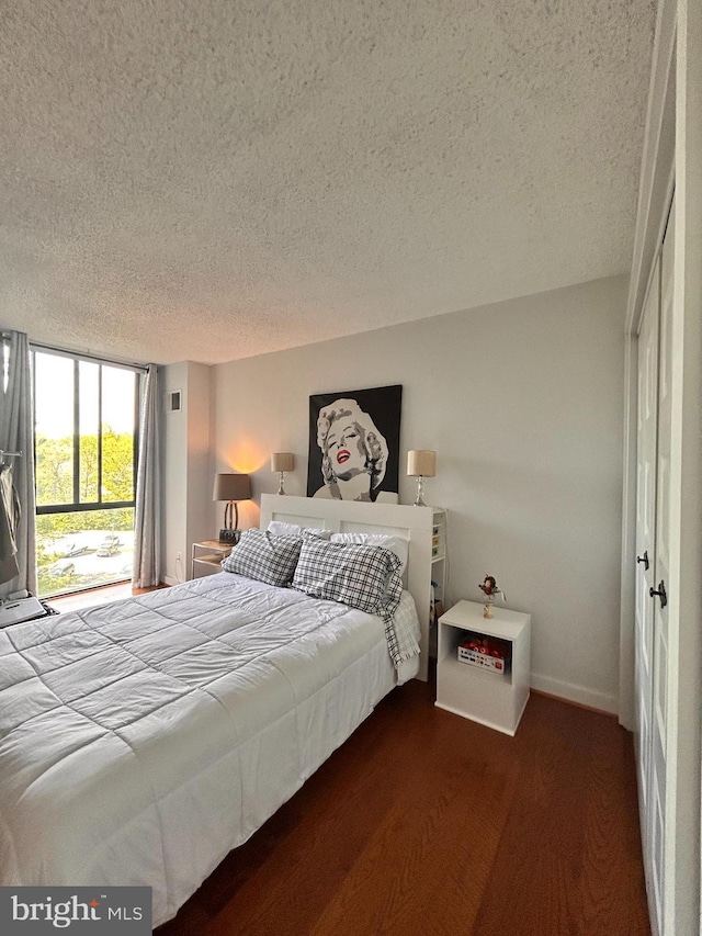 2300 Pimmit Dr Unit 601, Falls Church, VA 22043 - bedroom featuring wood finished floors, a textured ceiling, and baseboards