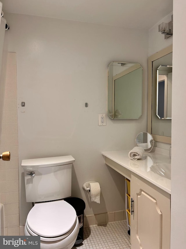 2300 Pimmit Dr Unit 601, Falls Church, VA 22043 - bathroom featuring baseboards, vanity, tile patterned flooring, and toilet