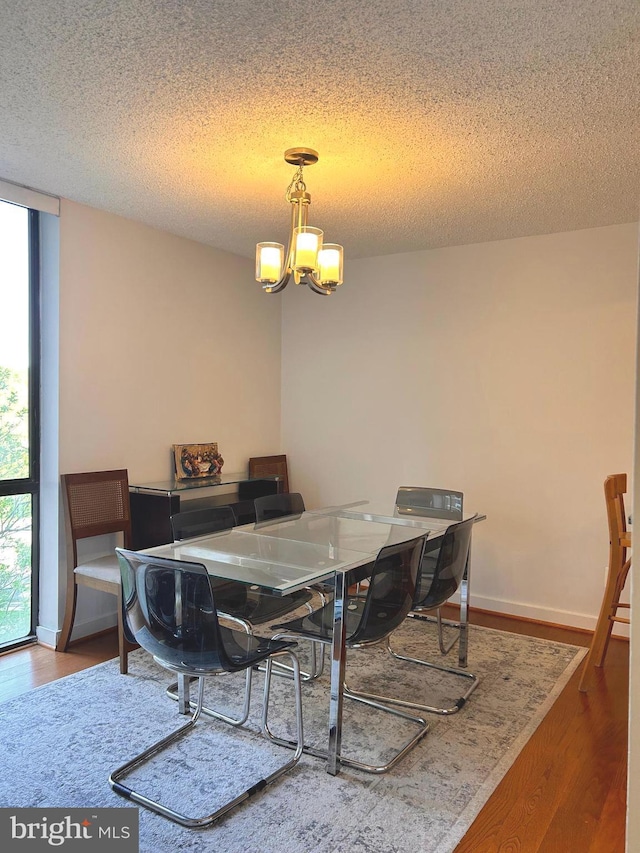 2300 Pimmit Dr Unit 601, Falls Church, VA 22043 - dining space with wood finished floors, a textured ceiling, and a notable chandelier