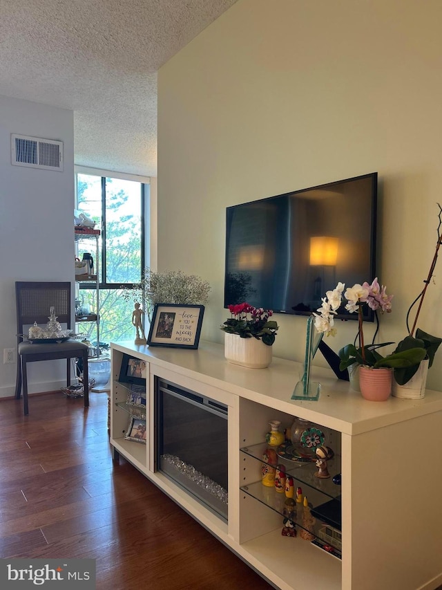 2300 Pimmit Dr Unit 601, Falls Church, VA 22043 - living room featuring floor to ceiling windows, dark wood-type flooring, visible vents, and a textured ceiling