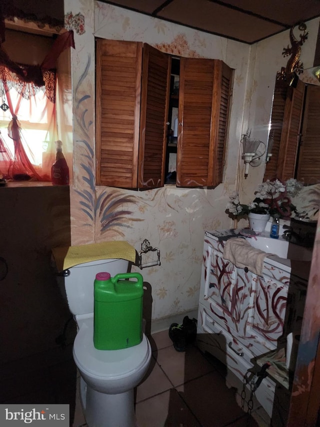 bathroom featuring tile patterned flooring, vanity, wallpapered walls, and toilet
