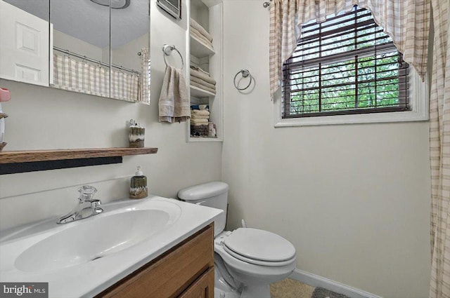 full bath featuring vanity and toilet