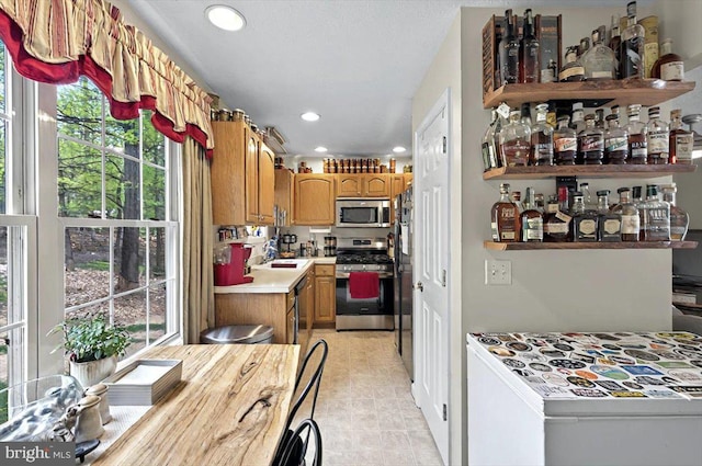 kitchen with light countertops, recessed lighting, appliances with stainless steel finishes, and plenty of natural light