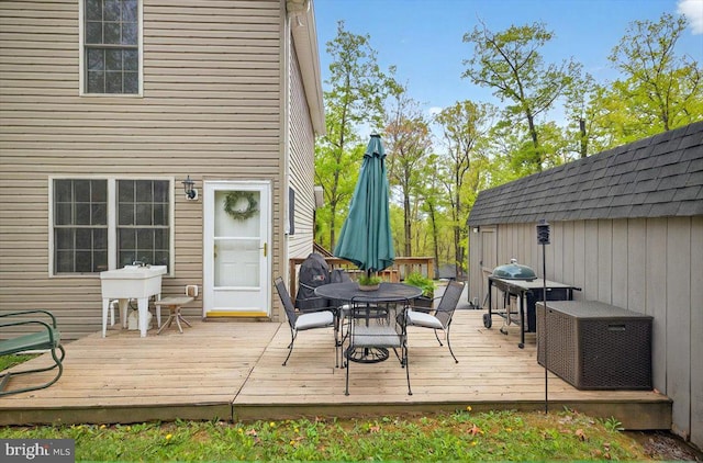 wooden terrace featuring outdoor dining space