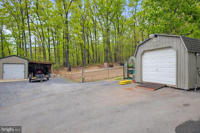 garage featuring a garage and fence