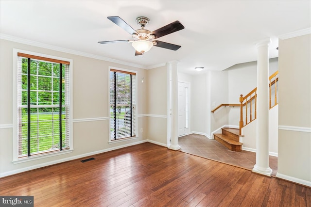 9409 Emory Grove Rd, Gaithersburg, MD 20877 - unfurnished room featuring ornate columns, wood-type flooring, baseboards, crown molding, and stairway