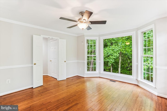 9409 Emory Grove Rd, Gaithersburg, MD 20877 - unfurnished room featuring healthy amount of natural light, hardwood / wood-style floors, baseboards, a ceiling fan, and ornamental molding