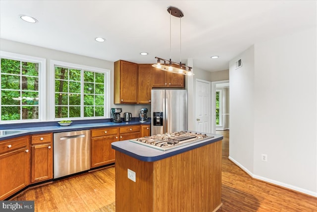 9409 Emory Grove Rd, Gaithersburg, MD 20877 - kitchen featuring stainless steel appliances, dark countertops, light wood-type flooring, brown cabinets, and recessed lighting