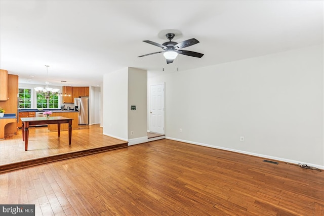 9409 Emory Grove Rd, Gaithersburg, MD 20877 - living room with a chandelier, light wood-style floors, baseboards, and ceiling fan