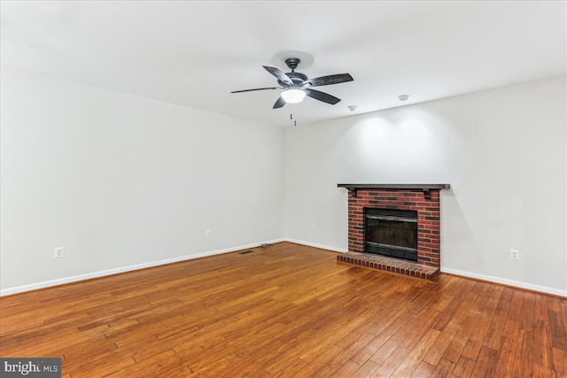 9409 Emory Grove Rd, Gaithersburg, MD 20877 - unfurnished living room featuring a brick fireplace, hardwood / wood-style floors, baseboards, and a ceiling fan