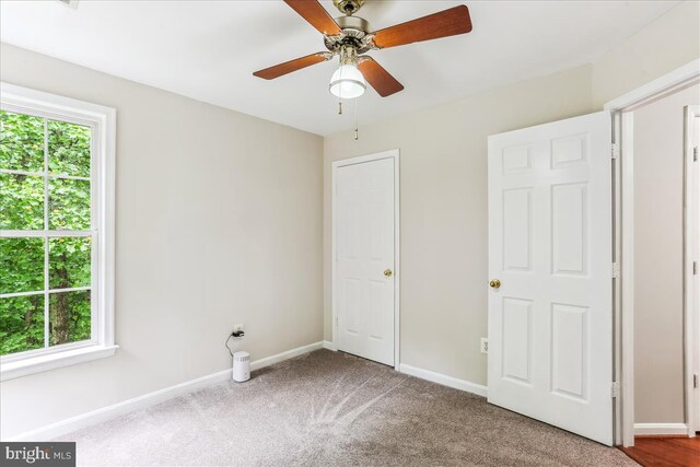 9409 Emory Grove Rd, Gaithersburg, MD 20877 - unfurnished bedroom with multiple windows, carpet, baseboards, and a ceiling fan