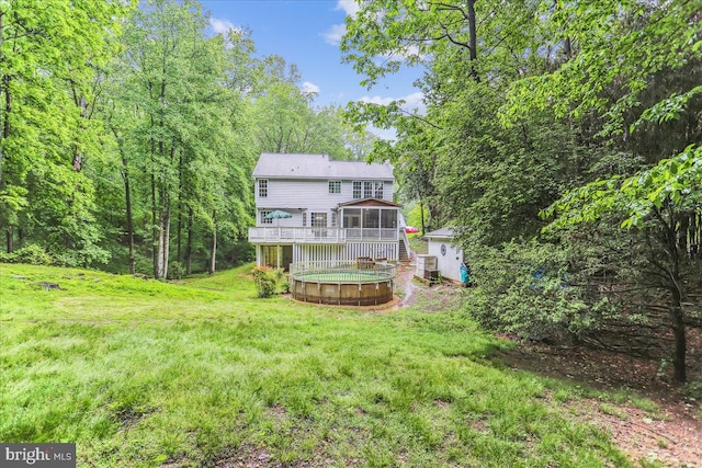 9409 Emory Grove Rd, Gaithersburg, MD 20877 - rear view of house featuring a wooden deck, a sunroom, a yard, a hot tub, and a wooded view