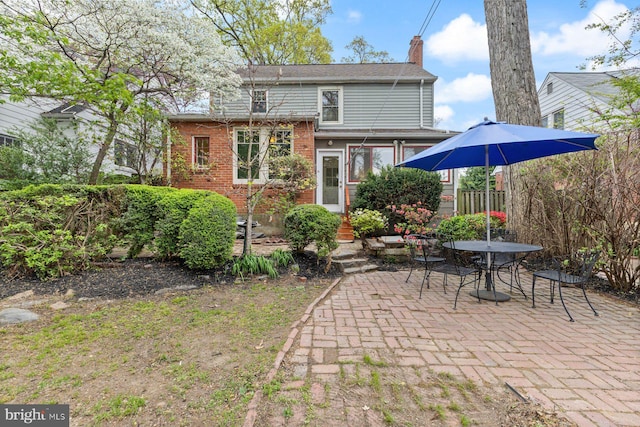 1412 N Wakefield St, Arlington, VA 22207 - rear view of house featuring brick siding, a patio area, a chimney, and entry steps