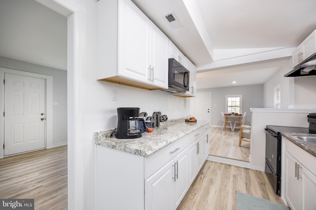 kitchen featuring light wood-style flooring, white cabinetry, visible vents, black appliances, and baseboards