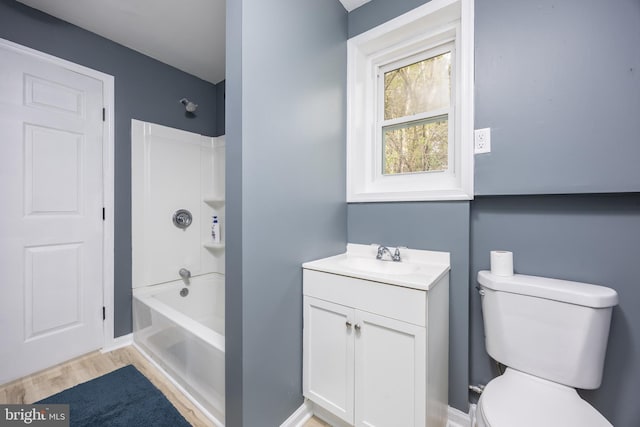full bathroom featuring toilet, wood finished floors, vanity, and shower / washtub combination