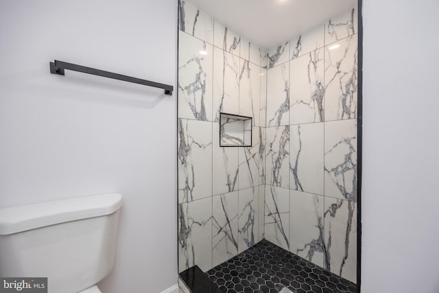 full bathroom with toilet and a marble finish shower