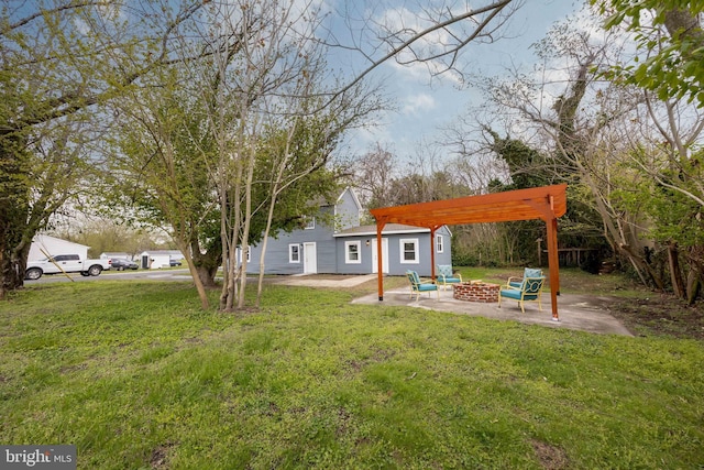 view of yard featuring a patio, a pergola, and a fire pit
