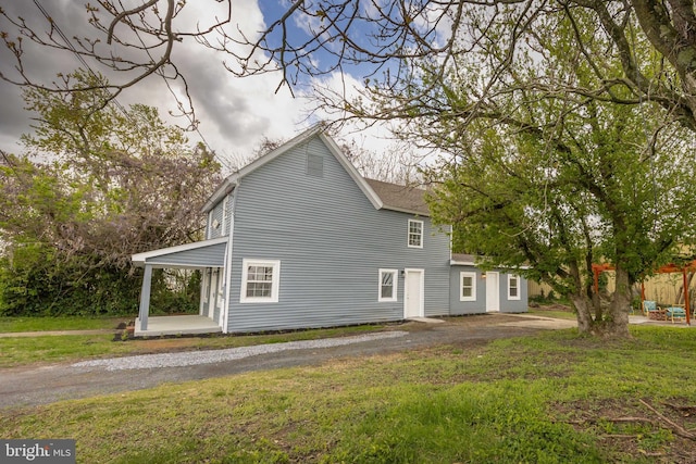 rear view of house with a lawn