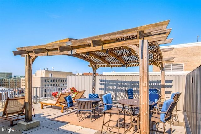 view of patio with fence, a pergola, and outdoor dining area