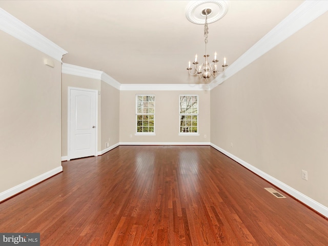 unfurnished dining area with crown molding, an inviting chandelier, dark wood-style floors, and visible vents