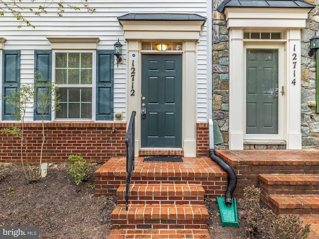entrance to property with brick siding