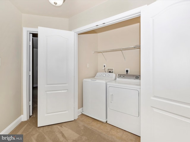 clothes washing area featuring washer and dryer, laundry area, and baseboards