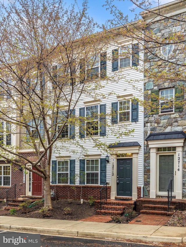 townhome / multi-family property with brick siding