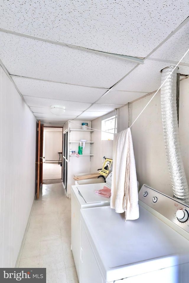 laundry area with washing machine and clothes dryer, laundry area, and baseboards